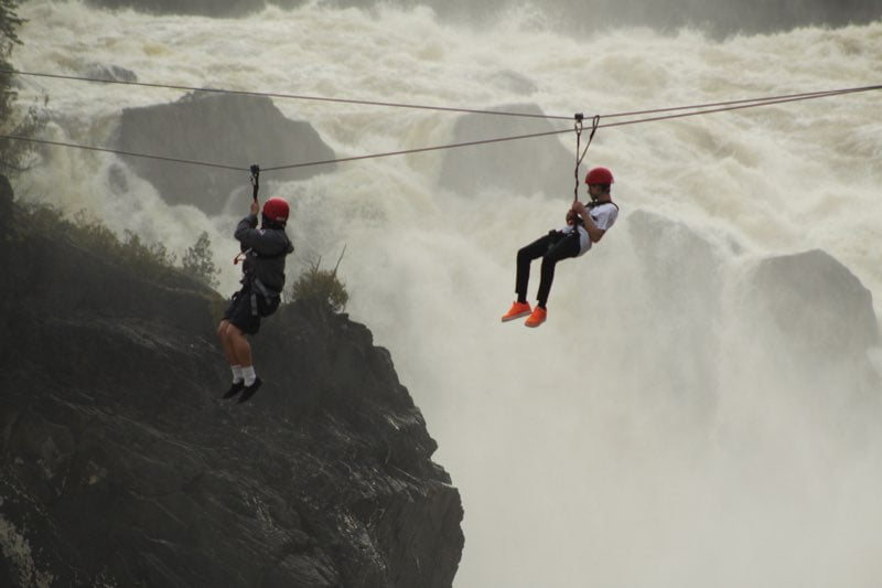 zip lining YMCA Academy students